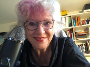 Foto von Sylvia Sänger mit einem Mikrofon.